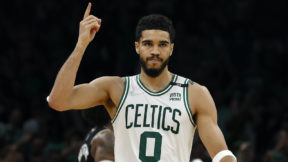 Jayson Tatum puts his hand in the air