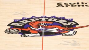 The Toronto Raptors logo at midcourt