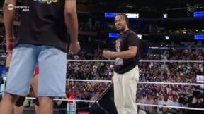 Jalen Brunson holding a steel chair in front of Tyrese Haliburton at a WWE show