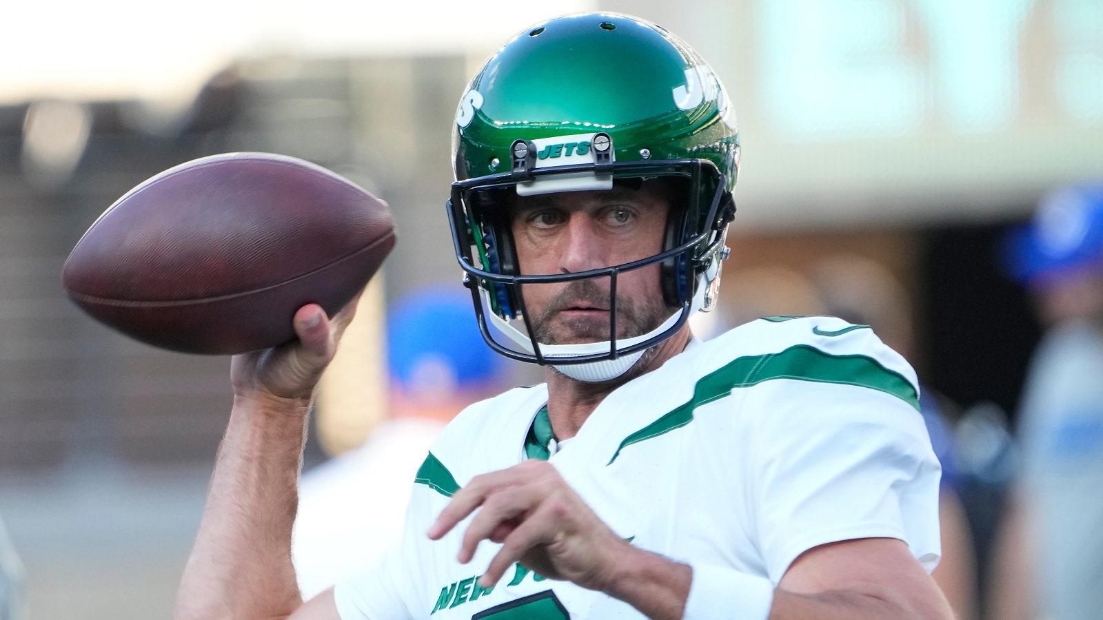 Aaron Rodgers in a Jets uniform ready to throw