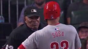 Edmundo Sosa and umpire Laz Diaz discuss a call