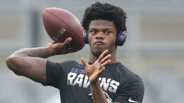 Lamar Jackson throws a pass in warmups