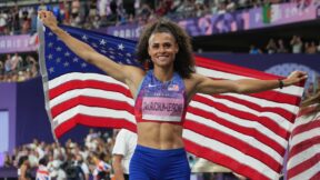 Sydney McLaughlin holding the American flag