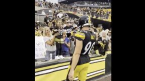 TJ Watt giving his glove to a young Steelers fan