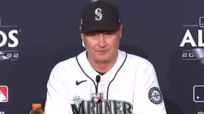 Scott Servais talks at a podium