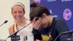 Caitlin Clark laughs during a press conference