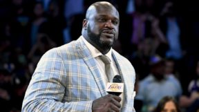 Shaq holds a mic