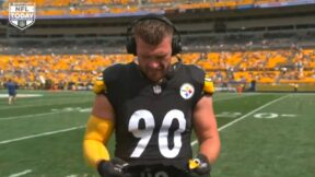 TJ Watt holding a jersey