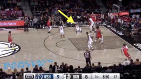 Kyle Kuzma takes a shot while Ben Simmons is on the ground during a Wizards-Nets preseason game