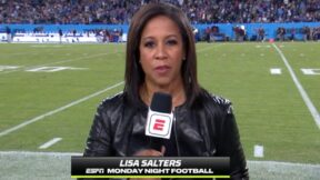 Lisa Salters holds a microphone